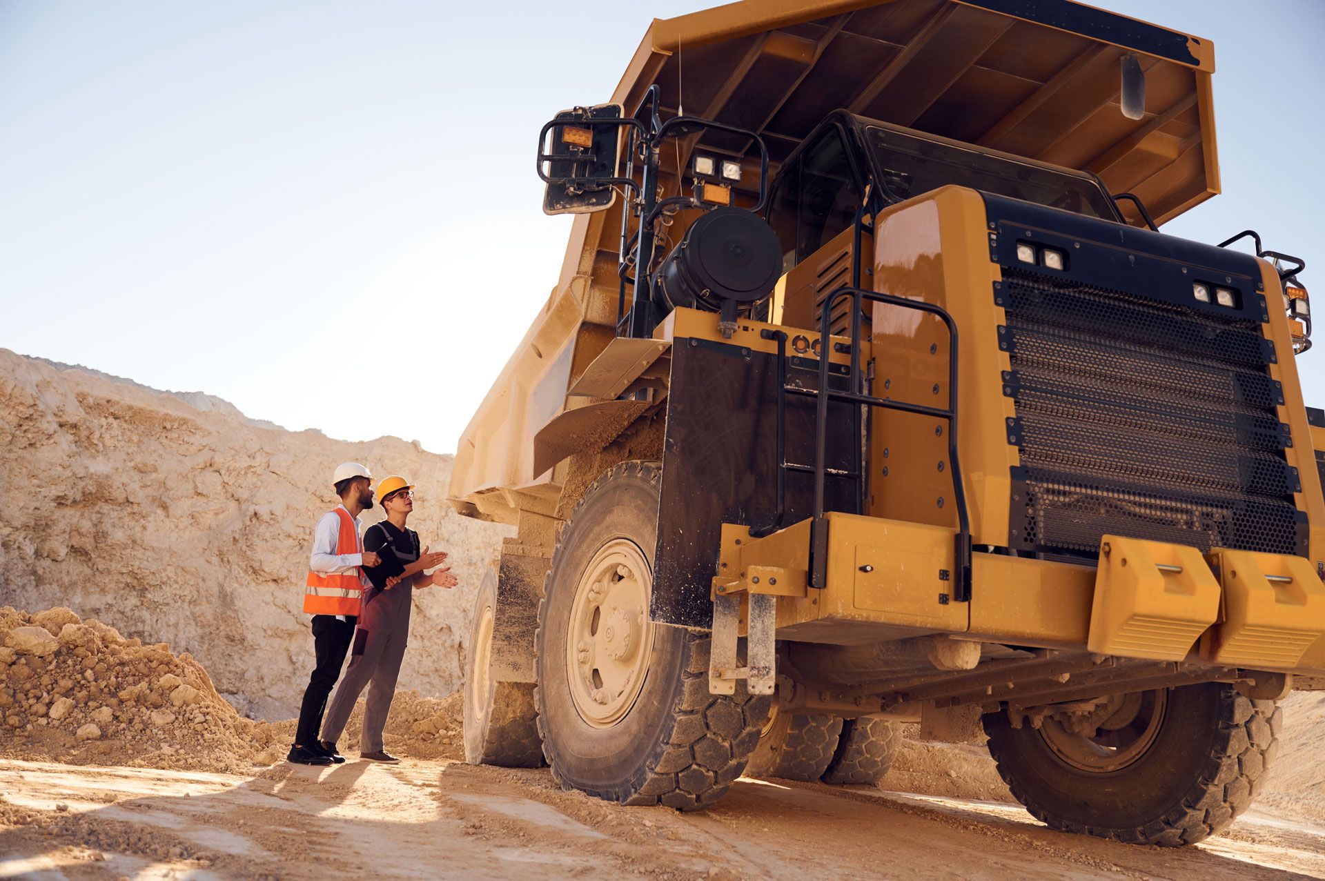 PSC Protect Perth services to mining, featuring a large haul truck and mine site personnel at an Australian mining operation.