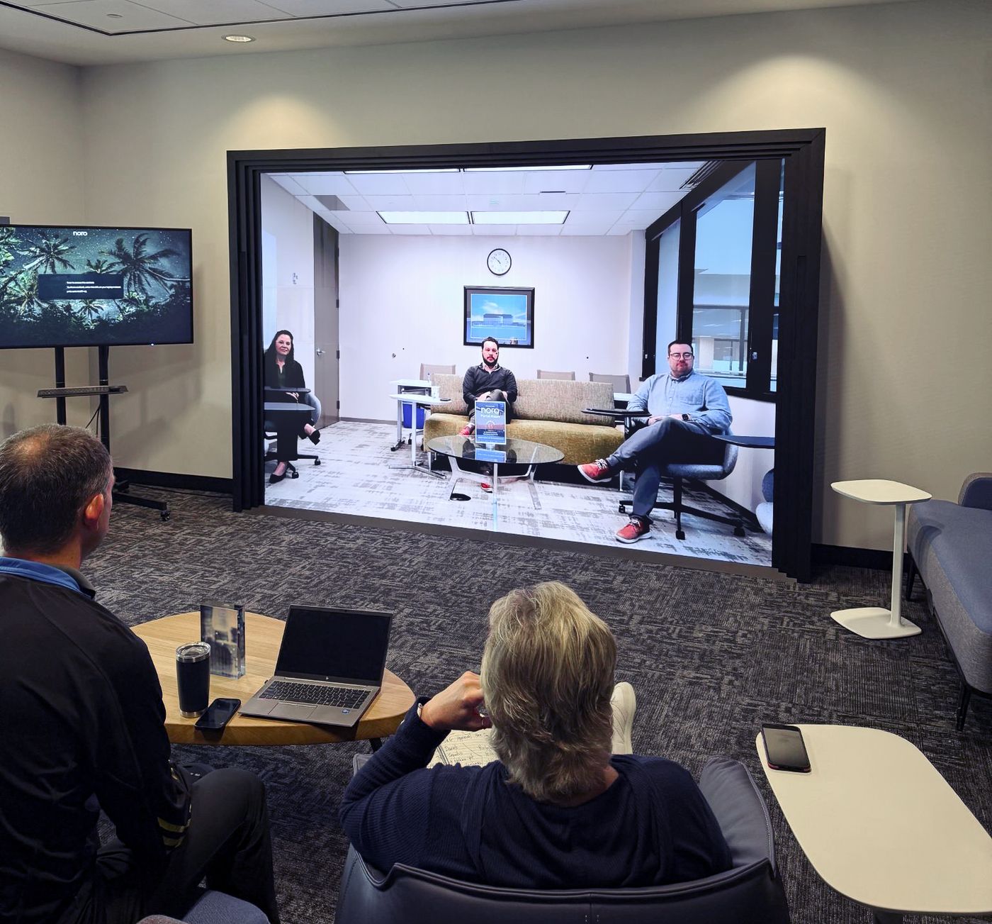 The Noro Room — a portal connecting two meeting rooms, with remote colleagues shown life-size