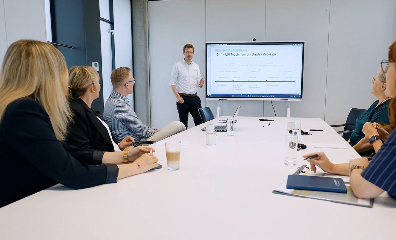 An employee is writing something on a whiteboard