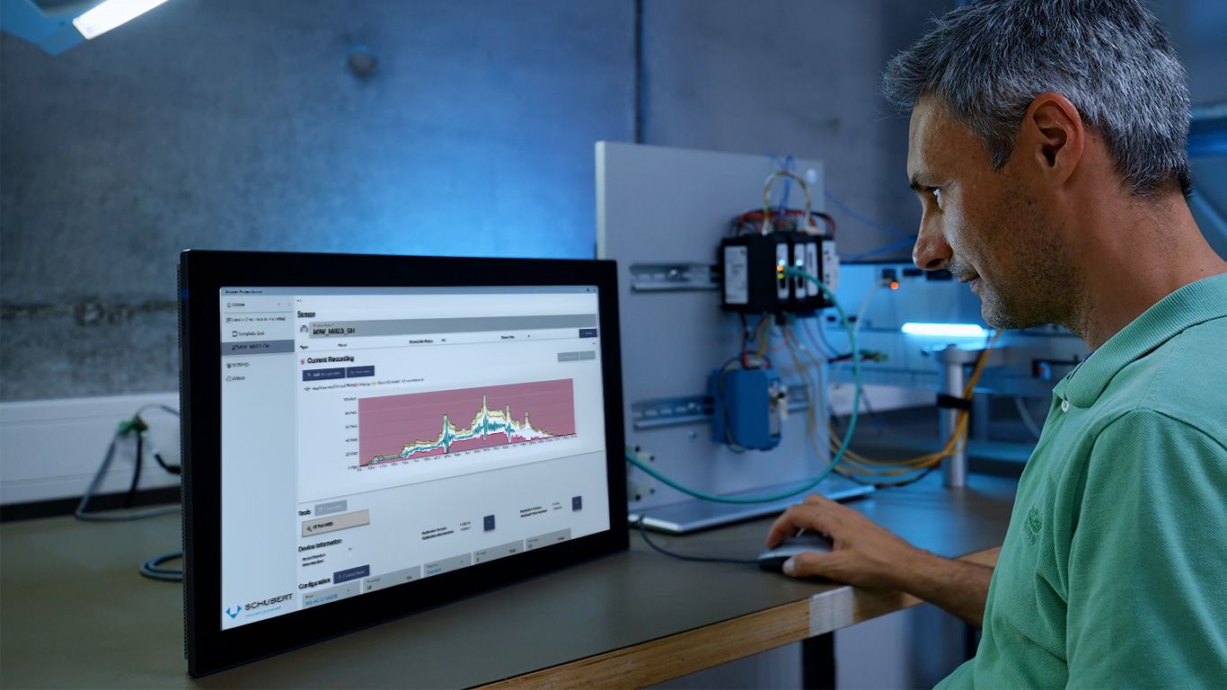Employee analyzing Power Monitoring teach curves on PC