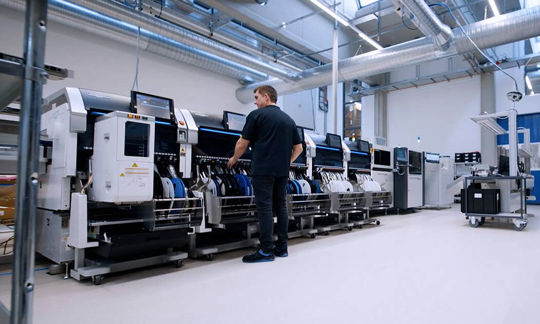 Employee in production on a HMI-Machine