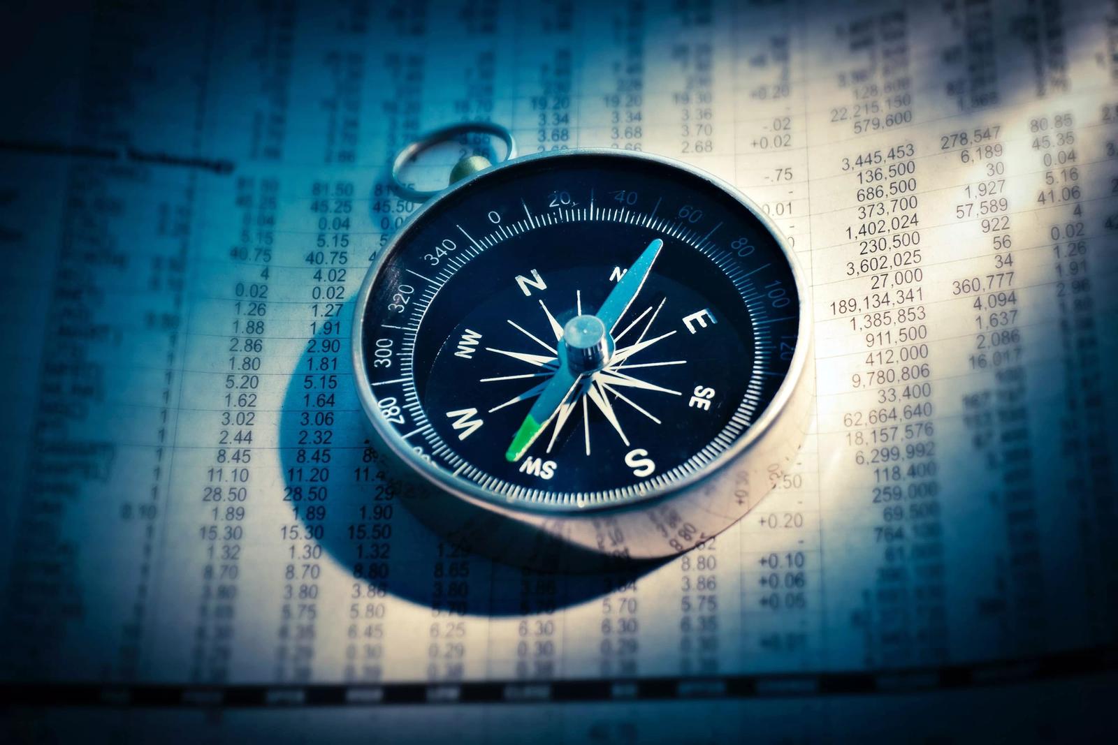 Image of compass resting on sheet of coordinates.