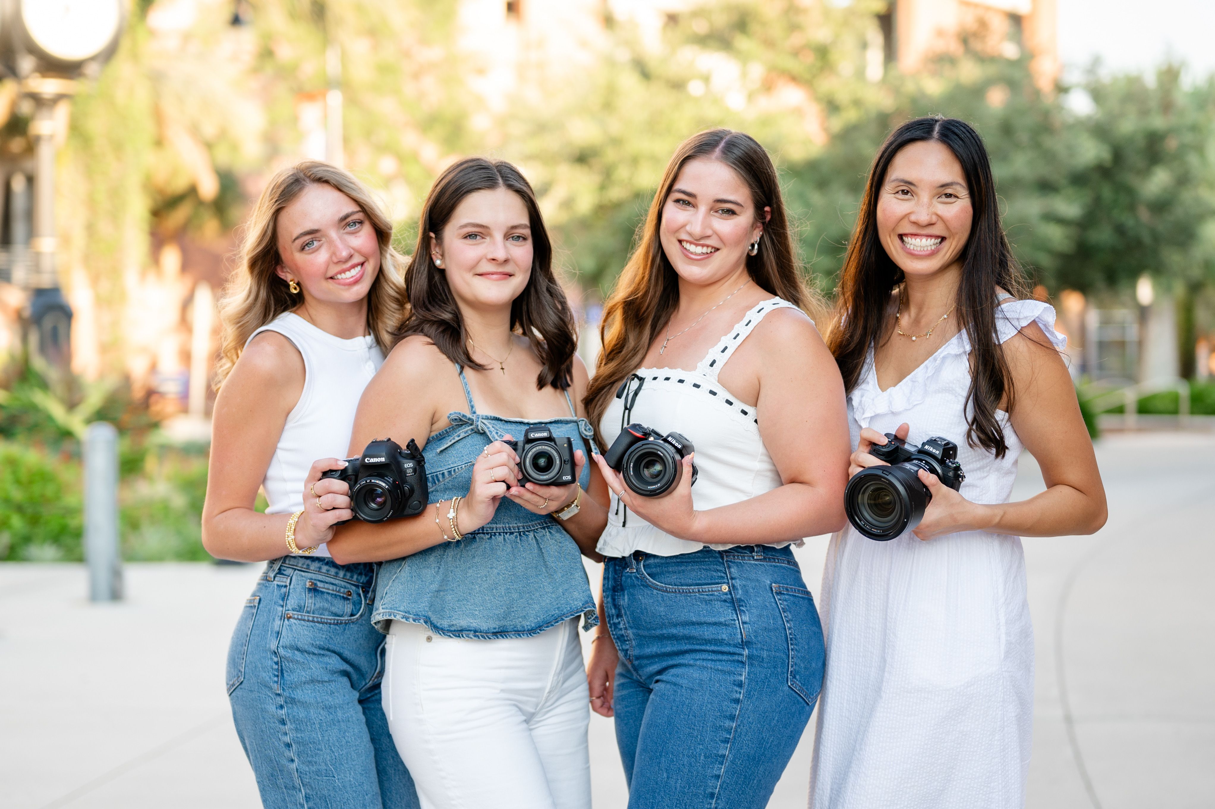 All associate photographers with Caitlyn smiling at the camera