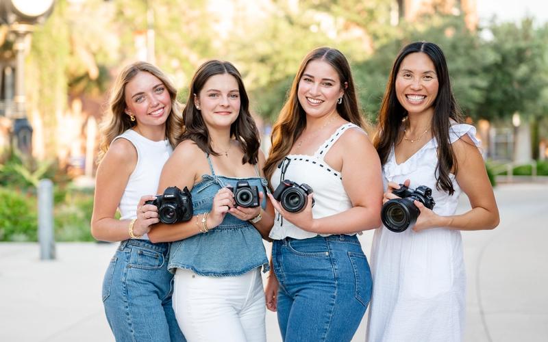 All associate photographers with Caitlyn smiling at the camera