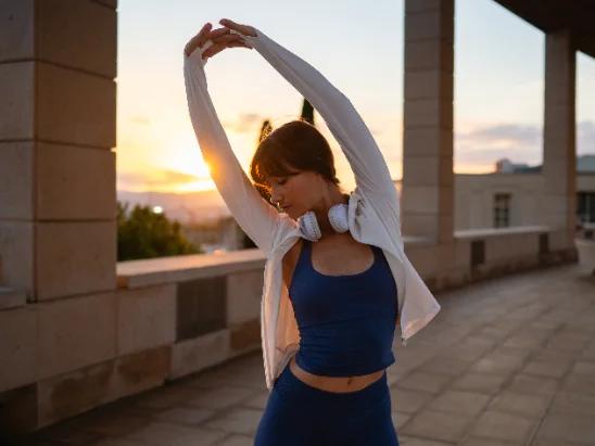 Person stretching or moving easily at home, warm light