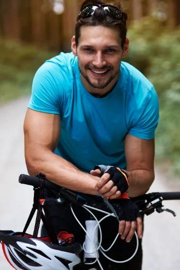 Runner or cyclist mid-40s catching breath, morning