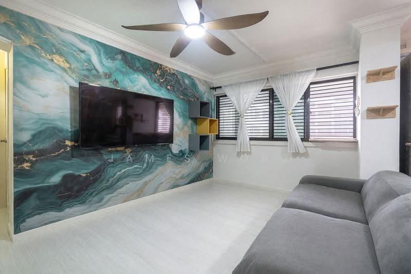Living room of the 4-room flat at 710 Woodlands Drive 70, with a feature wall and sofa