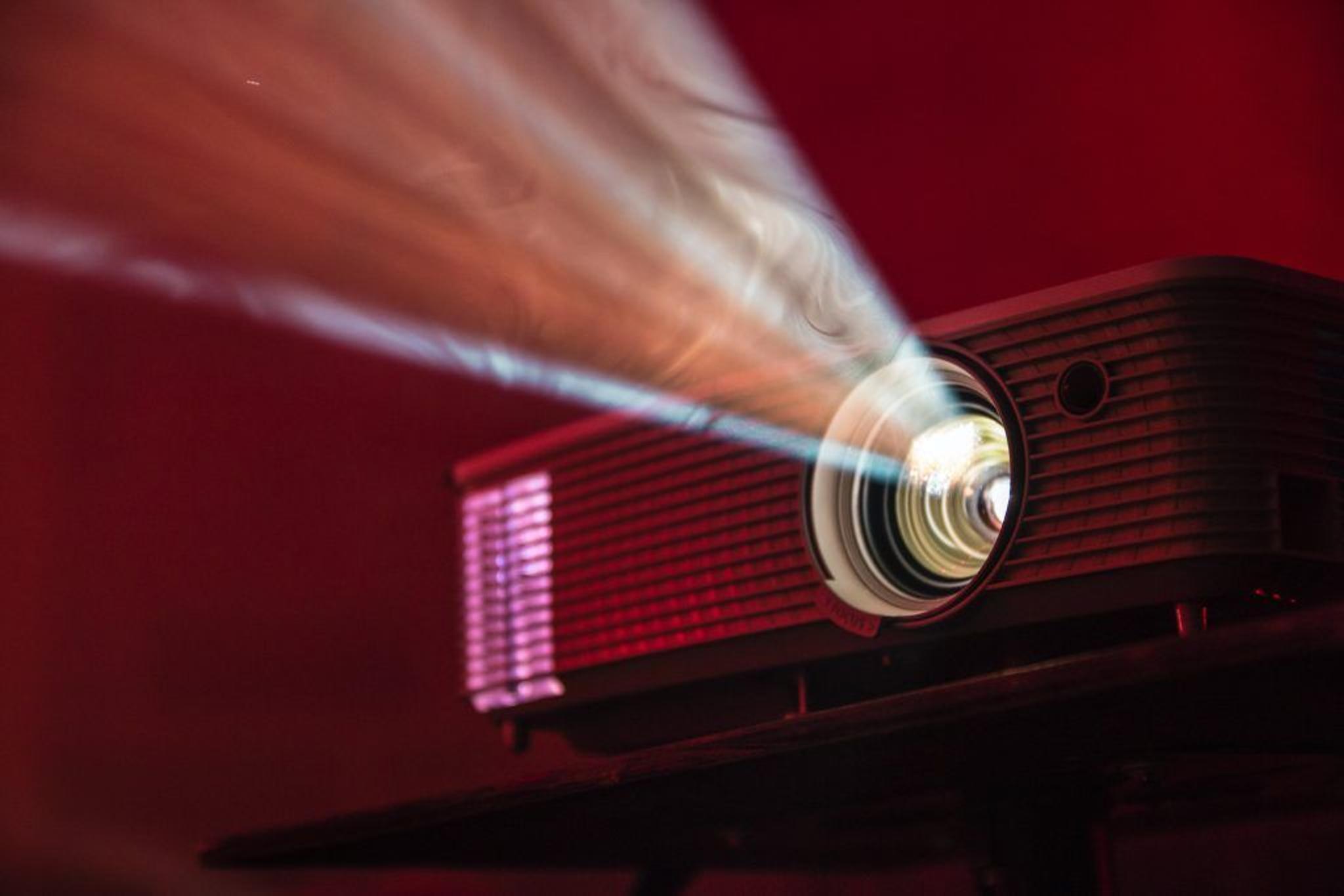 a projector is projecting a red light on a red background .
