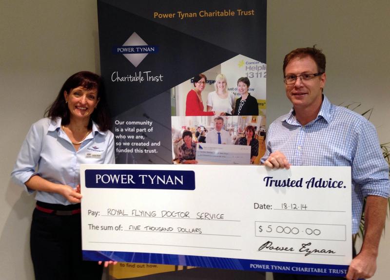 Power Tynan Director Justin Still hands the $5,000 cheque to Carolyn Bowes of RFDS.