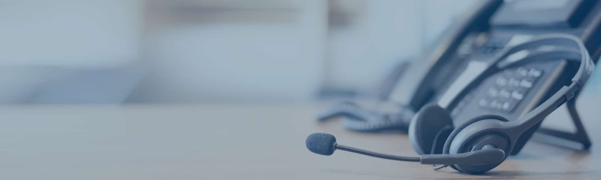 Close up image of corporate telephone with headset, representing blog titled: Sales process automation: Removing admin
