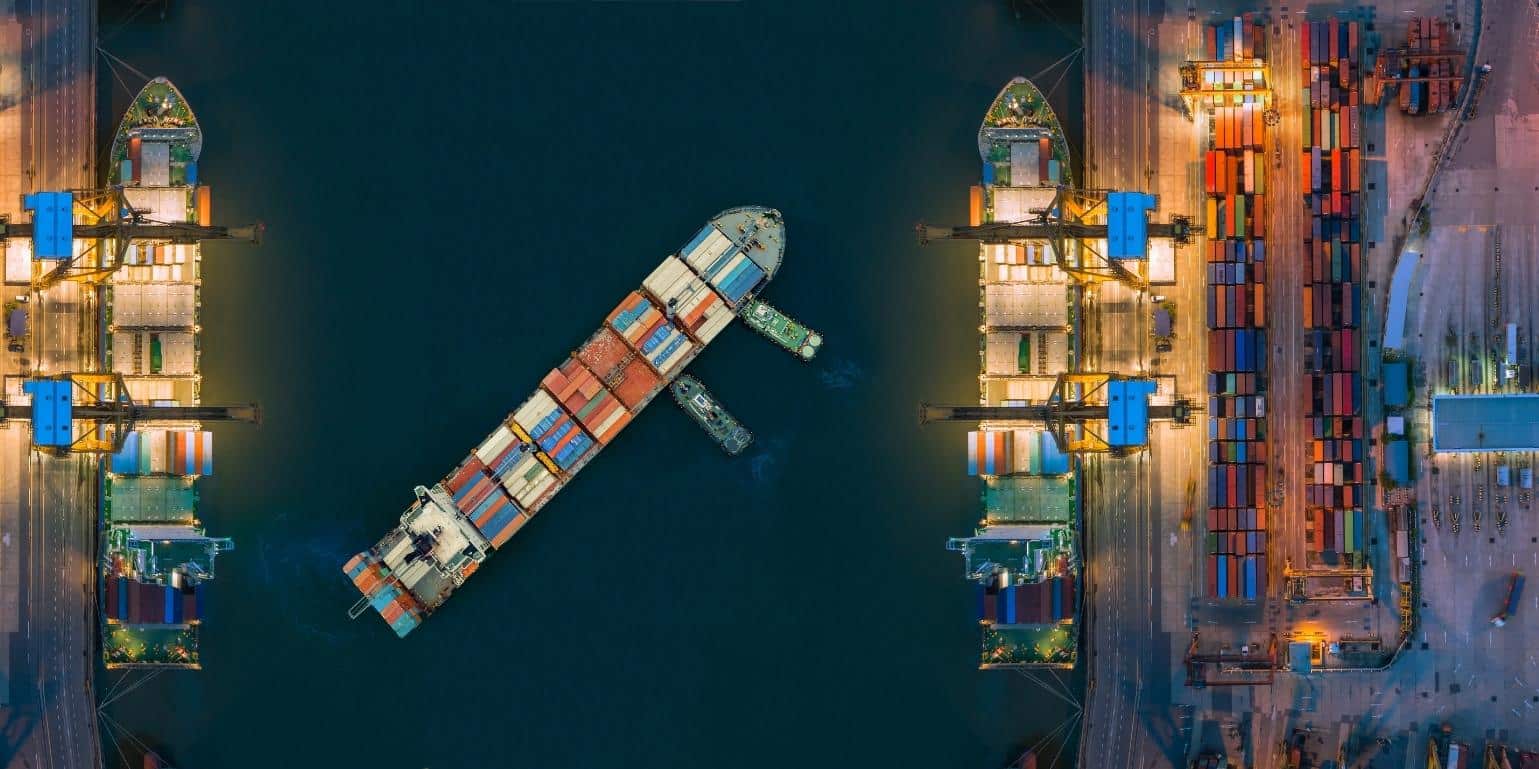 Birds-eye view of cargo ship with shipping containers for supply chain transport