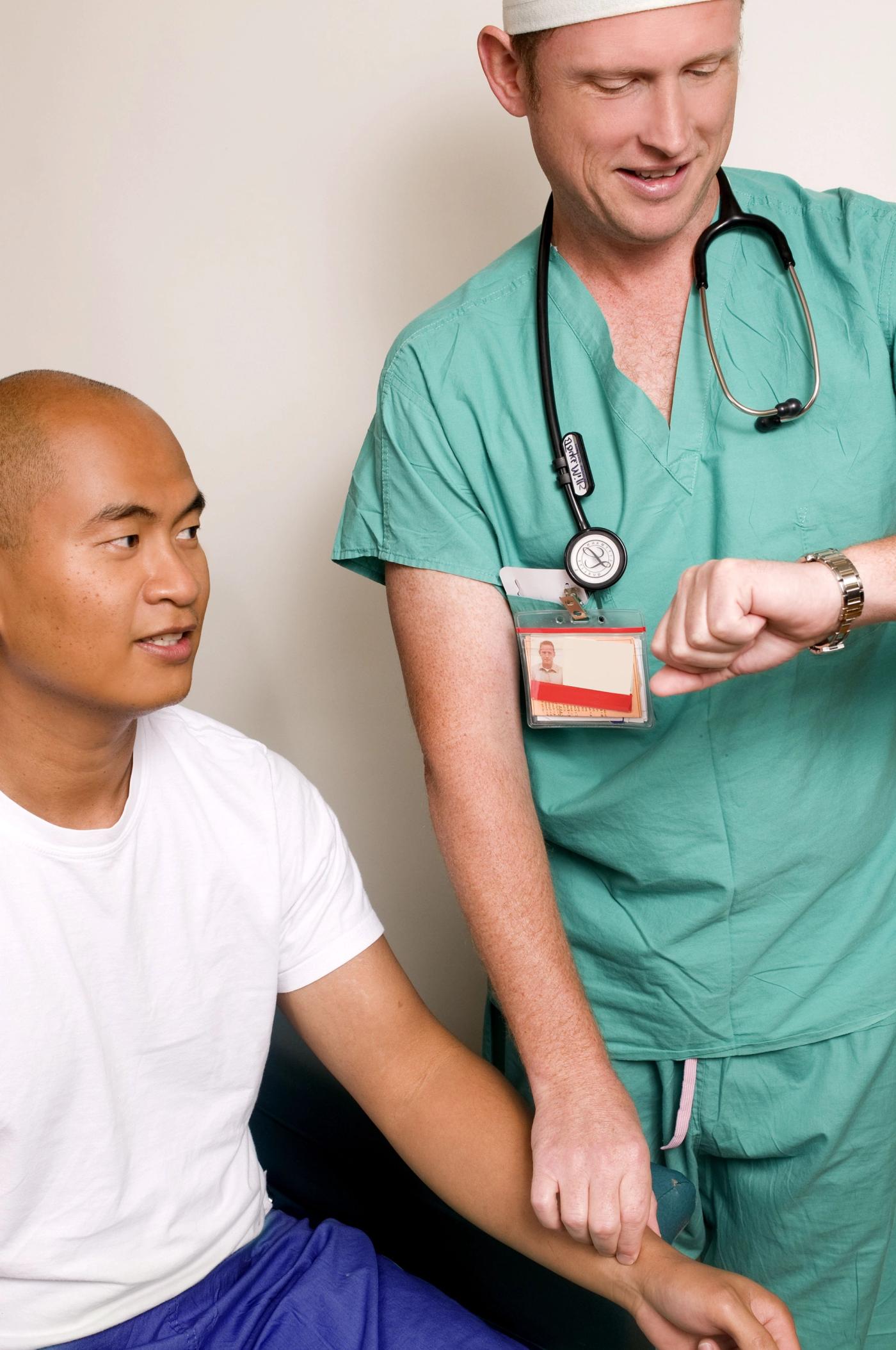 의료진이 손목시계를 보며 환자의 손목 맥박을 재는 모습