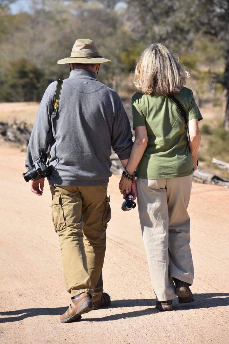 Couple Walking Hand In Hand On Safari