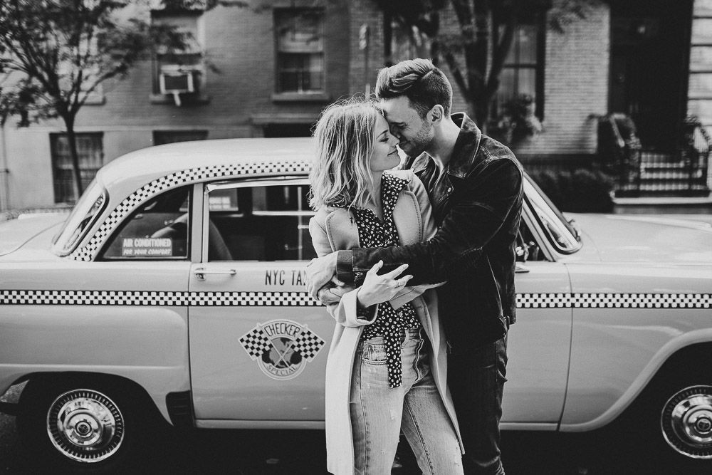 Couple by old taxi cab during nyc engagement photoshoot