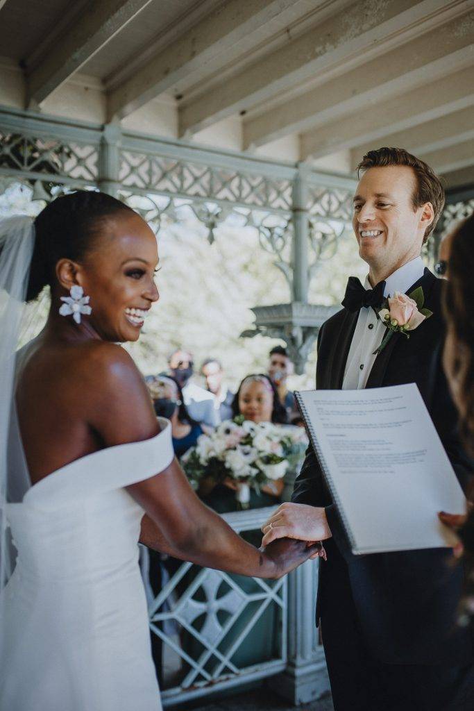 Wedding ceremony of biracial bride and groom in central park
