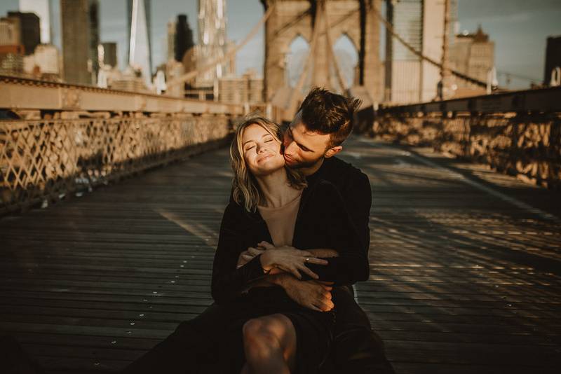 Couple on brooklyn bridge at sunrise during elopement photoshoot