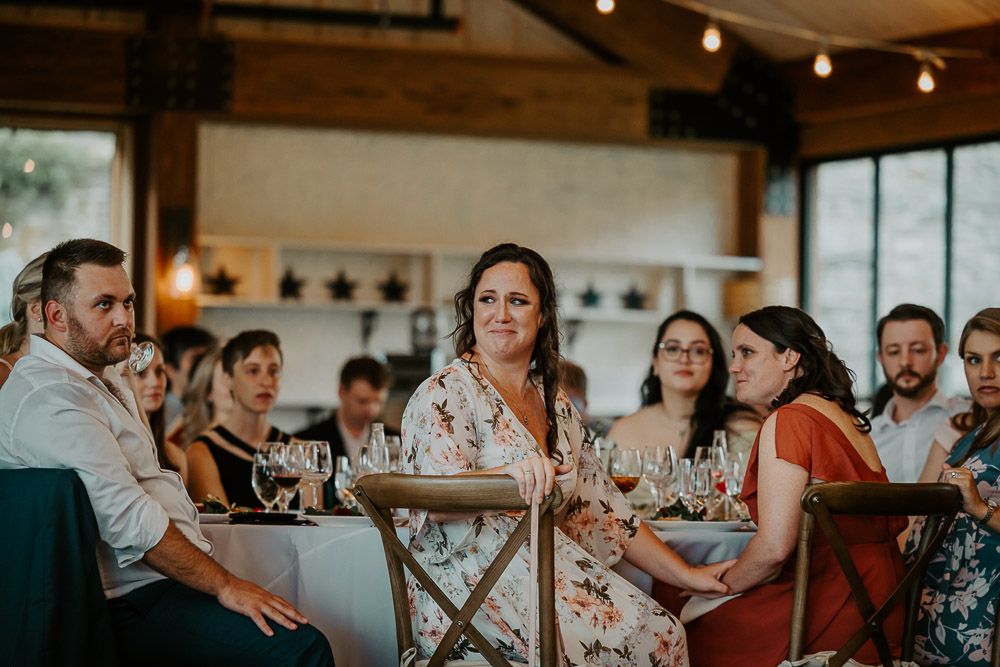 Maid of honor cries at red maple vineyard wedding reception