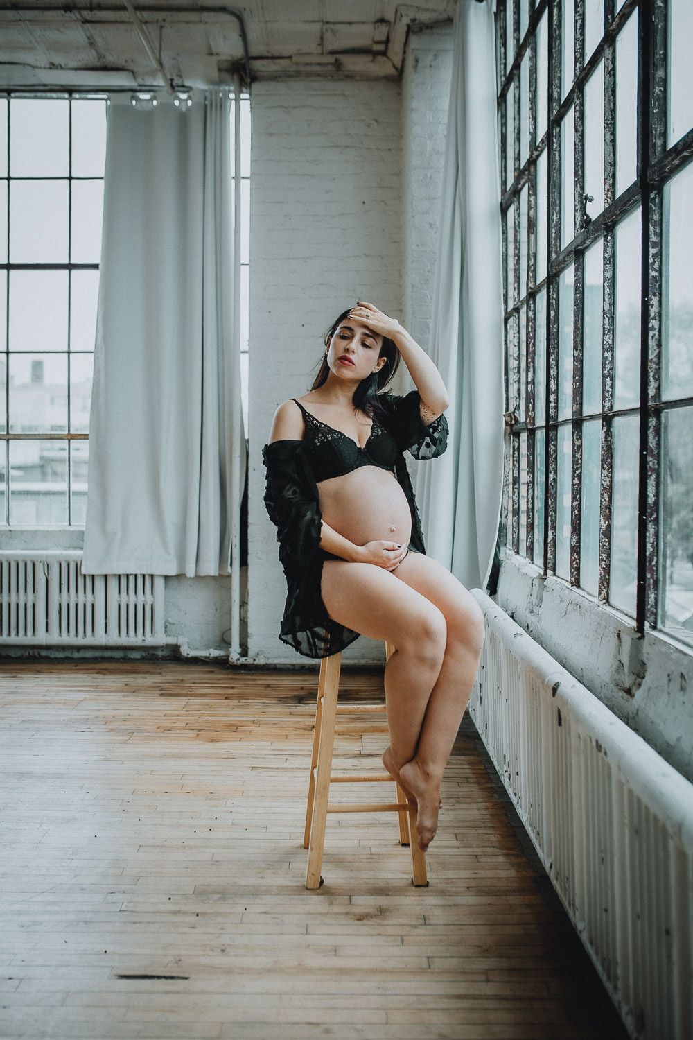 Pregnant woman during intimate maternity session at home in brooklyn
