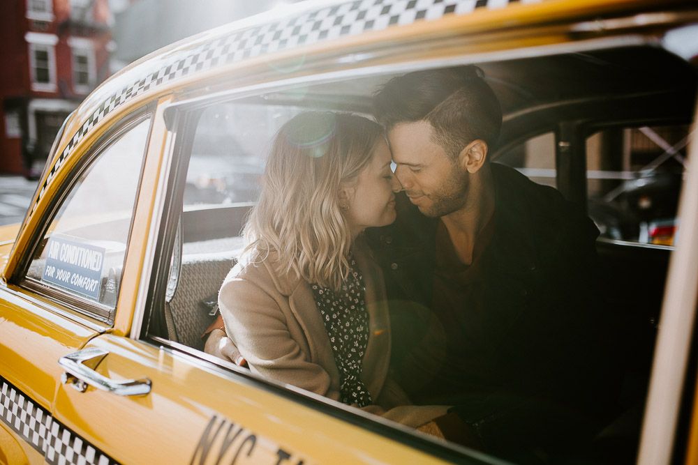 Couple by old taxi cab during nyc engagement photoshoot