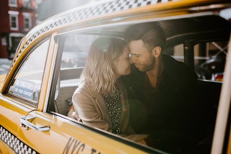 Couple by old taxi cab during nyc engagement photoshoot