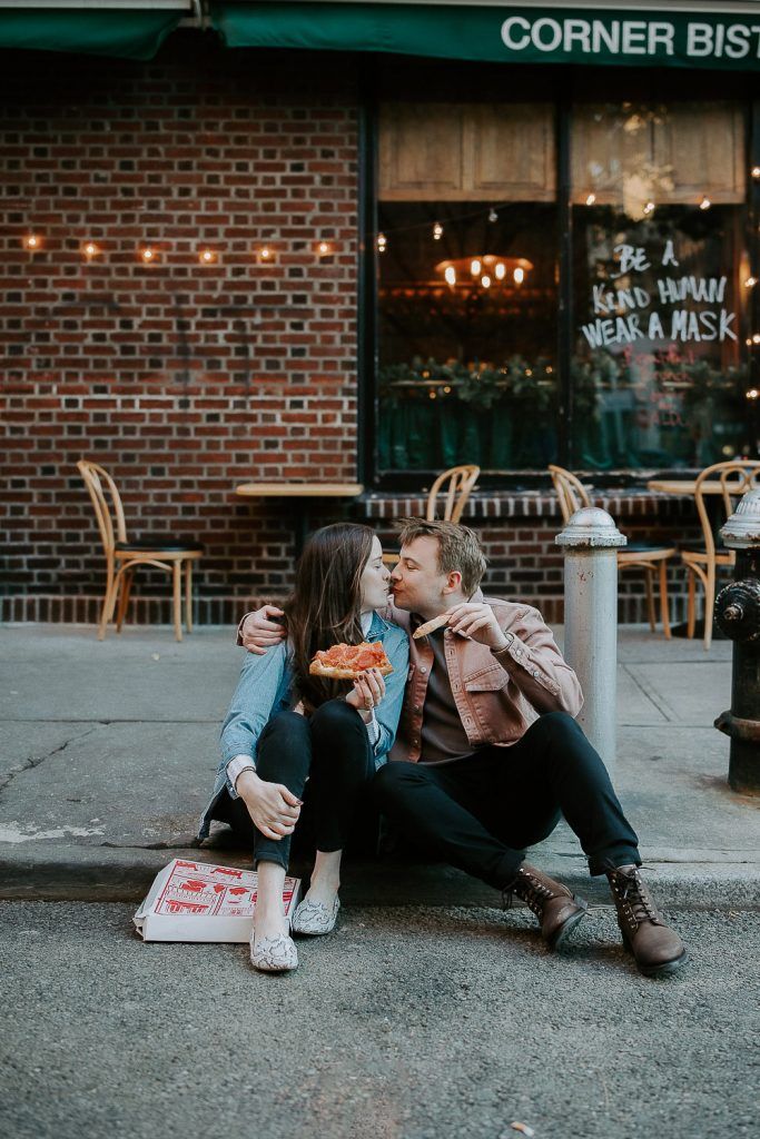 Couple eats pizza during engagement shoot in the west village of nyc