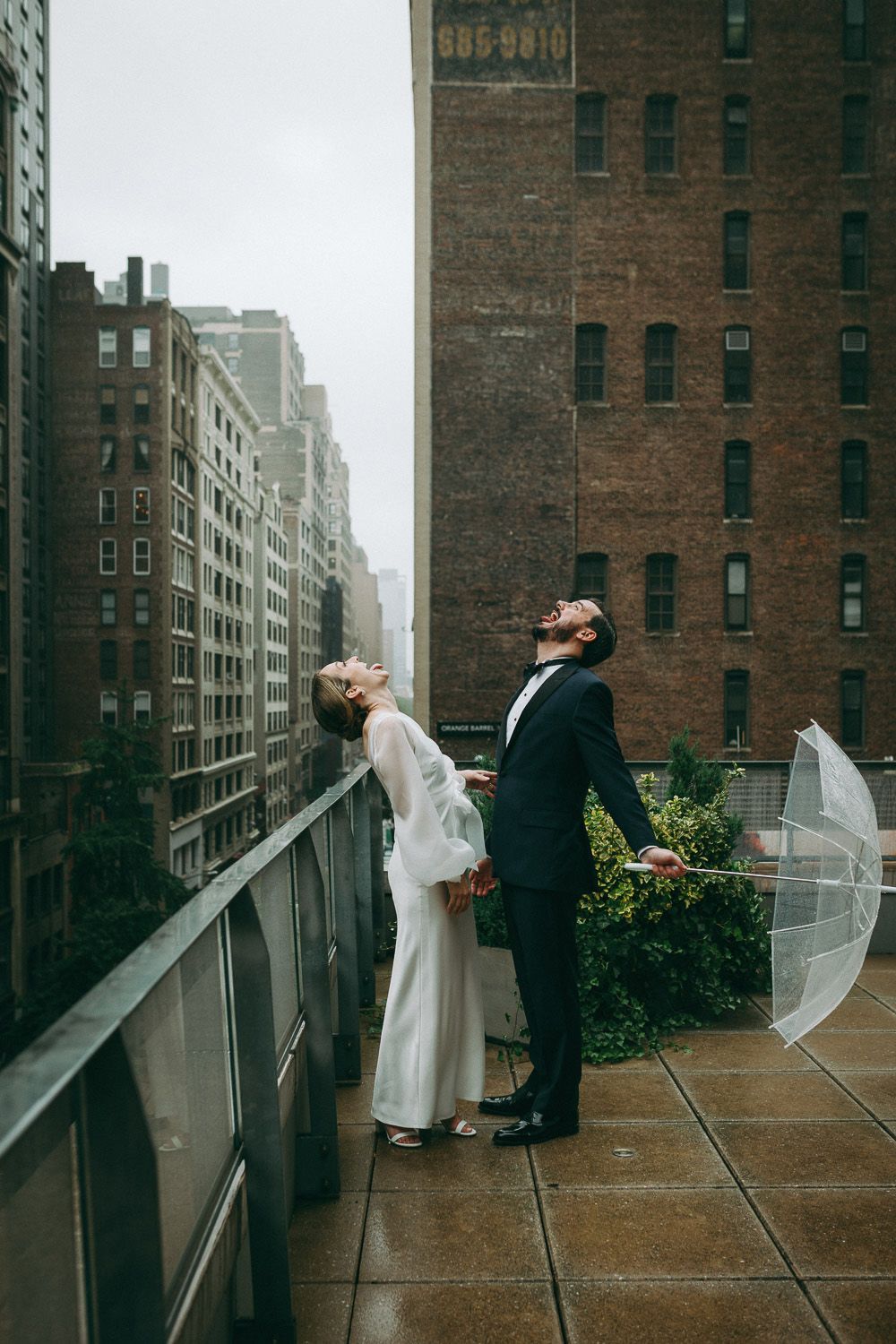 Bride and groom during rainy wedding on nyc rooftop