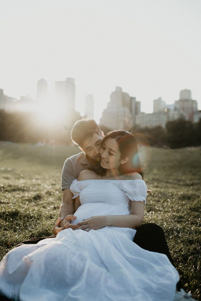 Expecting couple in central park at golden hour during maternity photoshoot