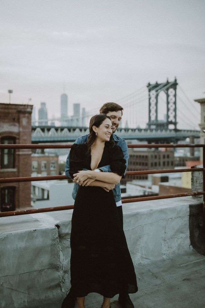 Couple on dumbo rooftop during brooklyn engagement session