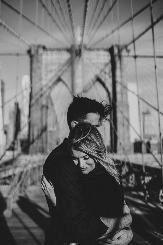 Couple on brooklyn bridge at sunrise during elopement photoshoot