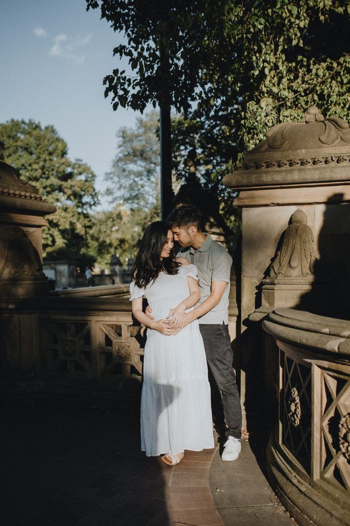 Expecting couple in central park at bethesda terrace during maternity photoshoot
