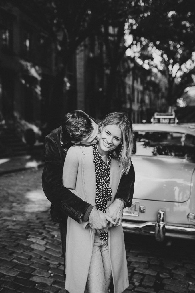 Couple by old taxi cab during nyc engagement photoshoot