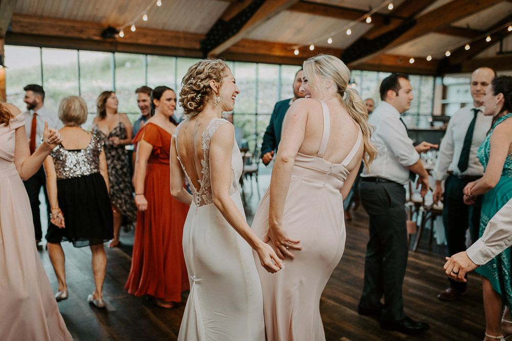 Bride dancing at red maple vineyard wedding reception