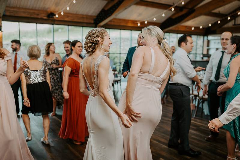 Bride dancing at red maple vineyard wedding reception