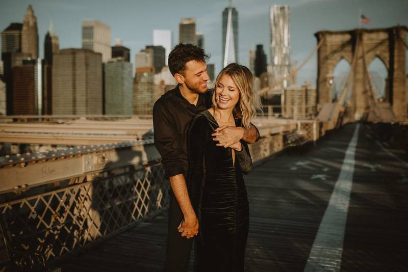 Couple on brooklyn bridge at sunrise during elopement photoshoot