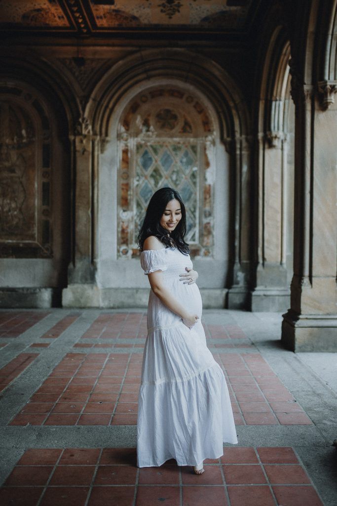 Pregnant woman in central park at bethesda terrace during maternity photoshoot