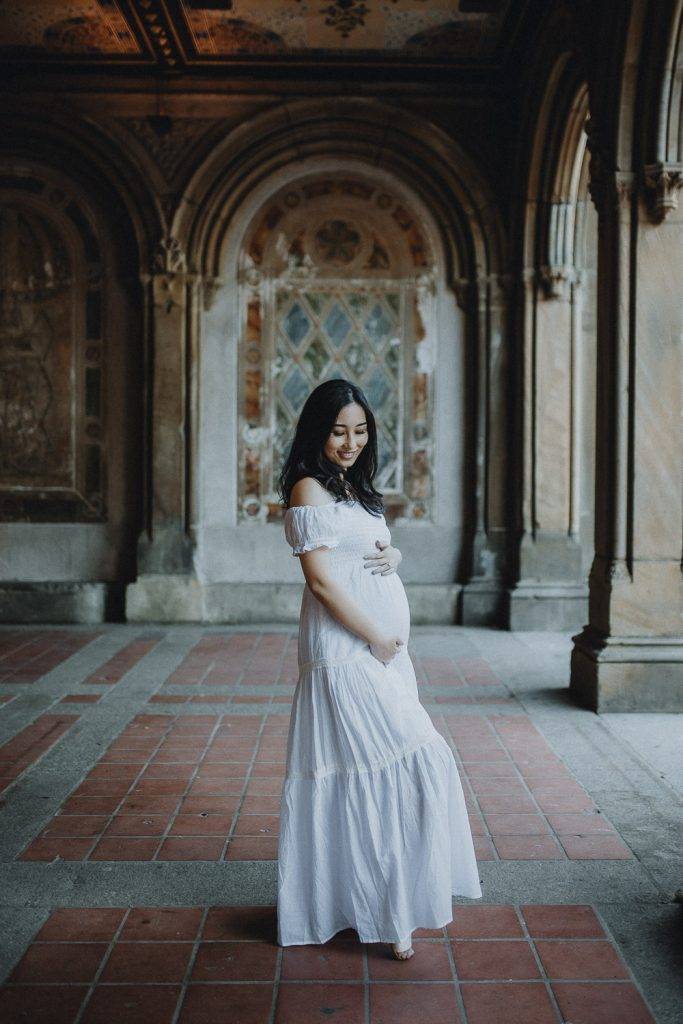 Pregnant woman in central park at bethesda terrace during maternity photoshoot