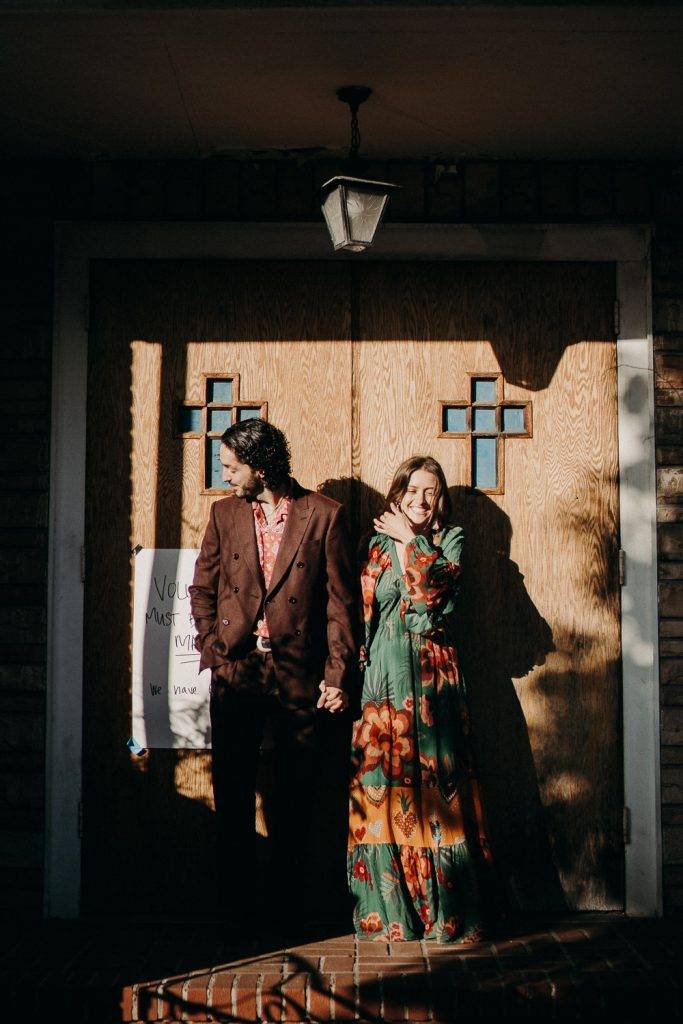 Couple laughing in front of church during brooklyn elopement