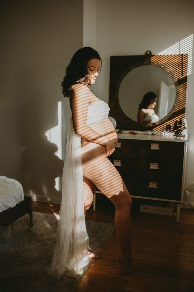 Naked pregnant woman during maternity photoshoot at home in brooklyn