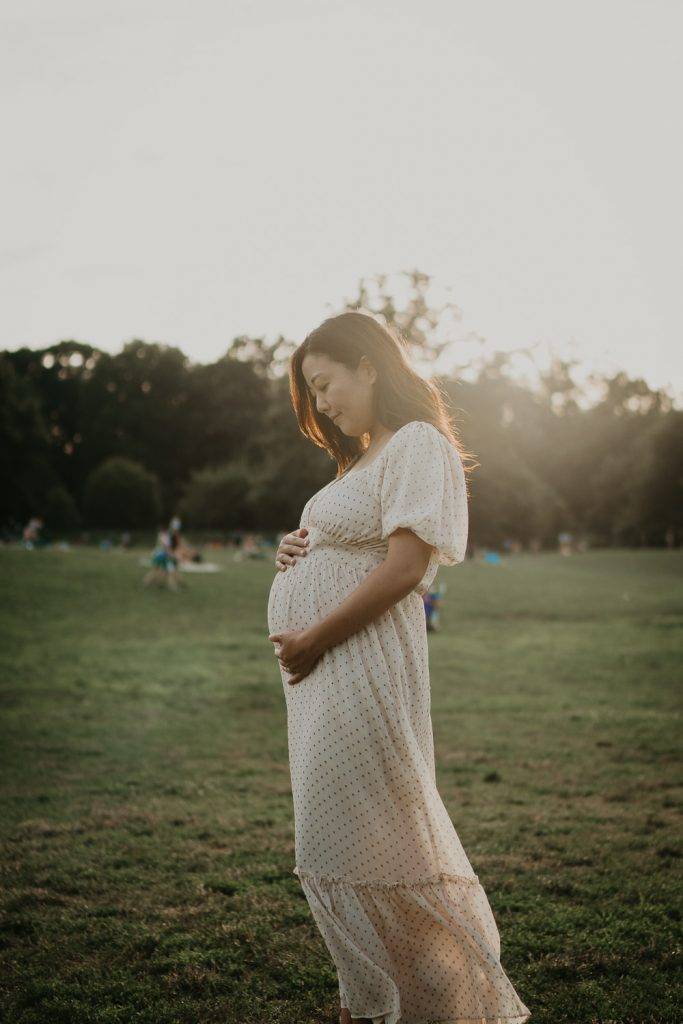 Pregnant woman in prospect park at golden hour during maternity session