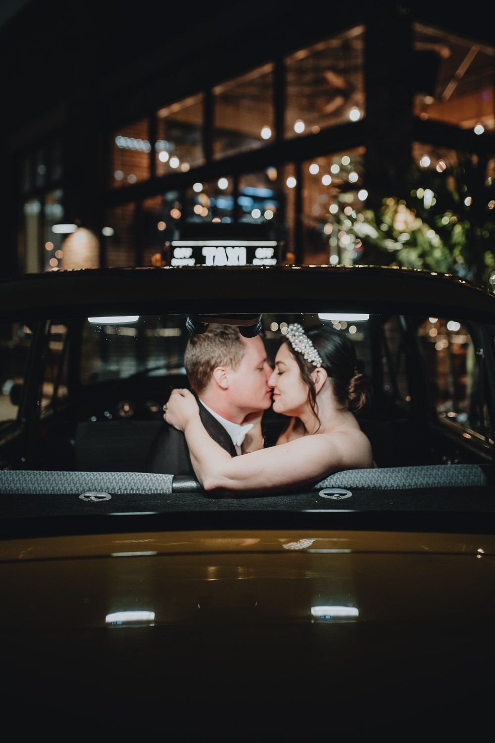 Bride and groom at night wedding in nyc vintage yellow cab