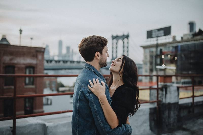 Couple on dumbo rooftop during brooklyn engagement session
