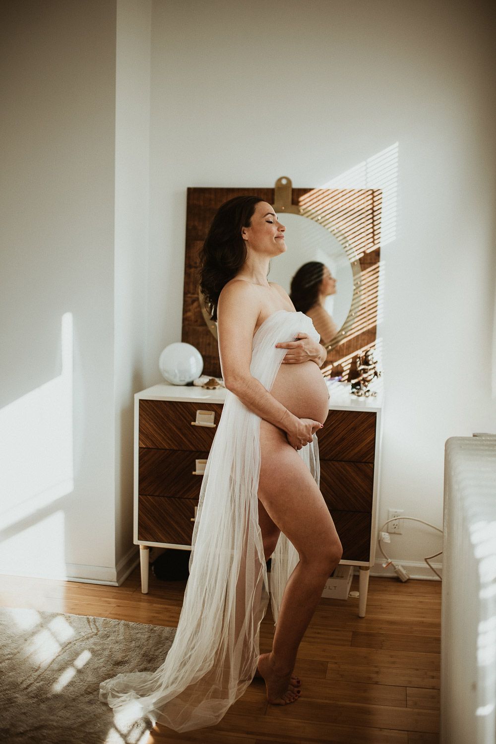Naked pregnant woman during maternity photoshoot at home in brooklyn