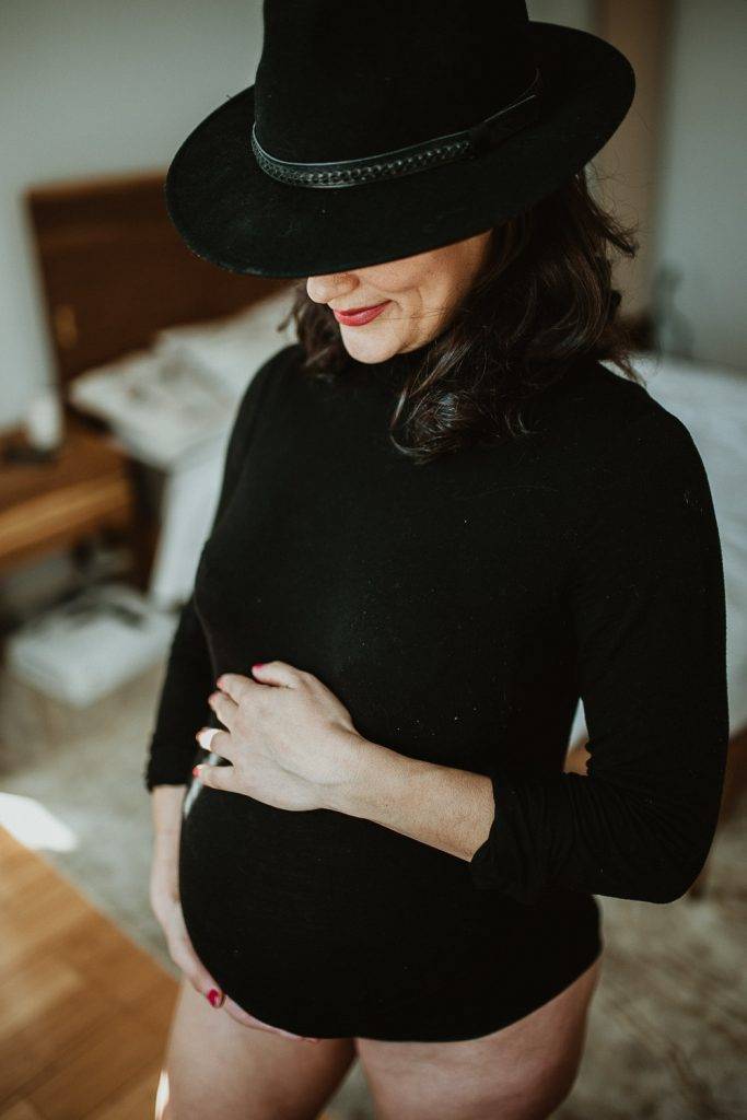 Pregnant woman with black bodysuit during maternity photoshoot in brooklyn home