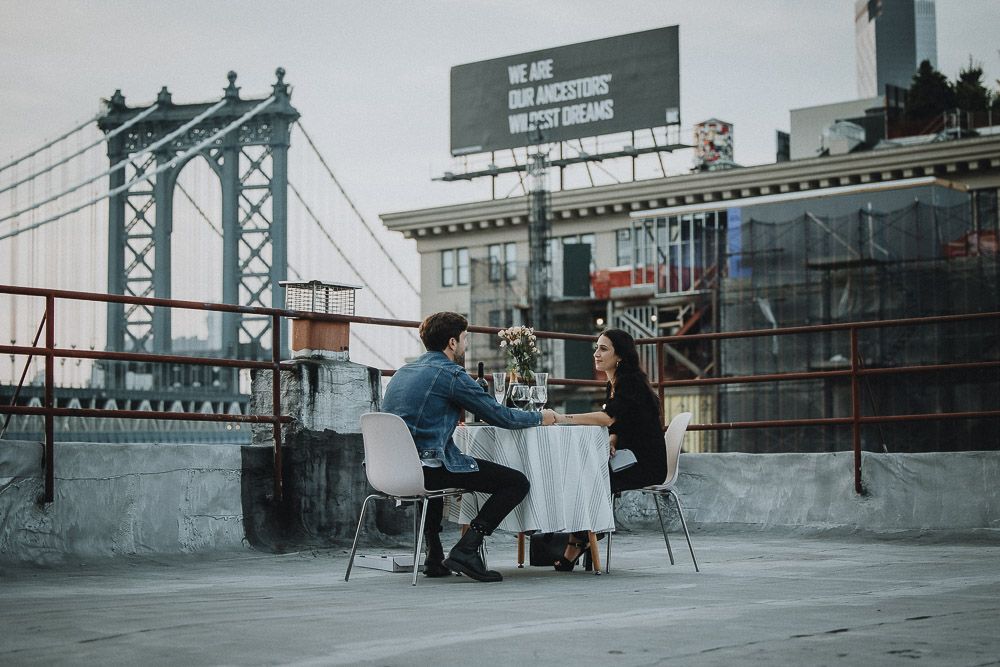 Couple on dumbo rooftop during brooklyn proposal