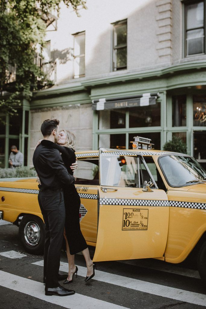 Couple by old taxi cab during nyc engagement photoshoot