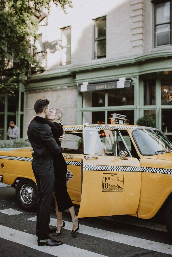 Couple by old taxi cab during nyc engagement photoshoot