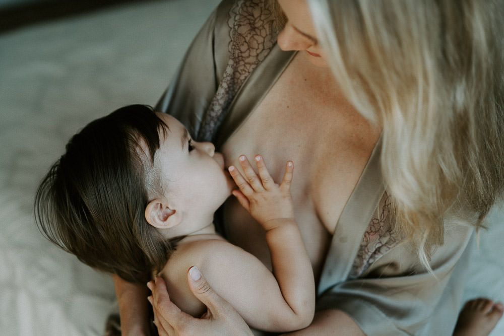 Baby breastfeeding mom during in home family session in brooklyn