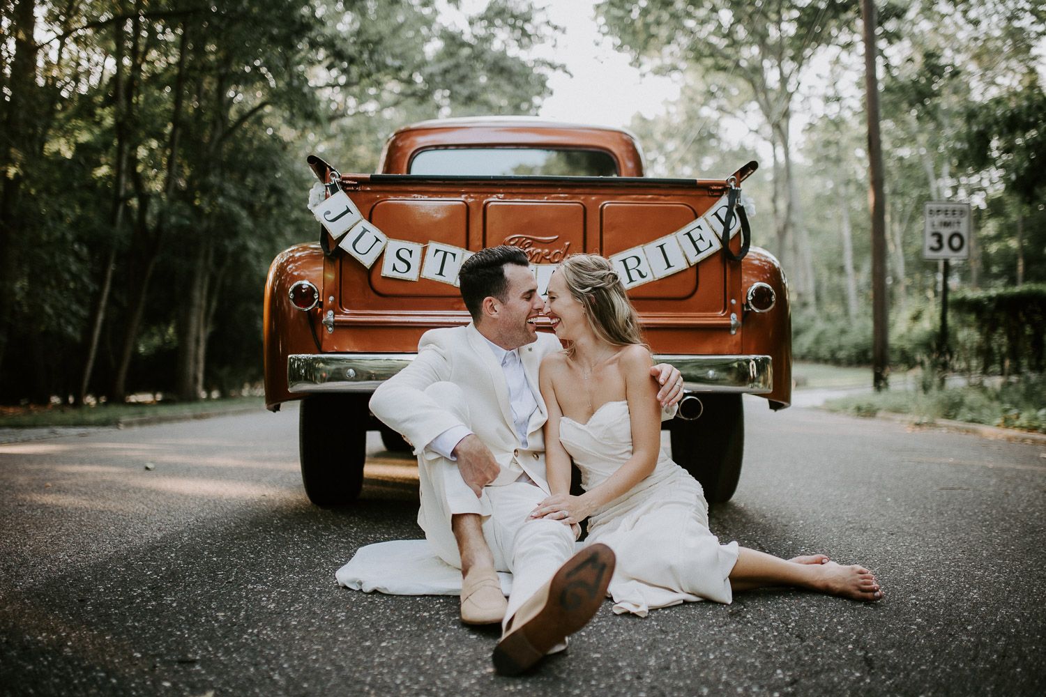 Bride and groom in vintage Ford truck at hamptons wedding