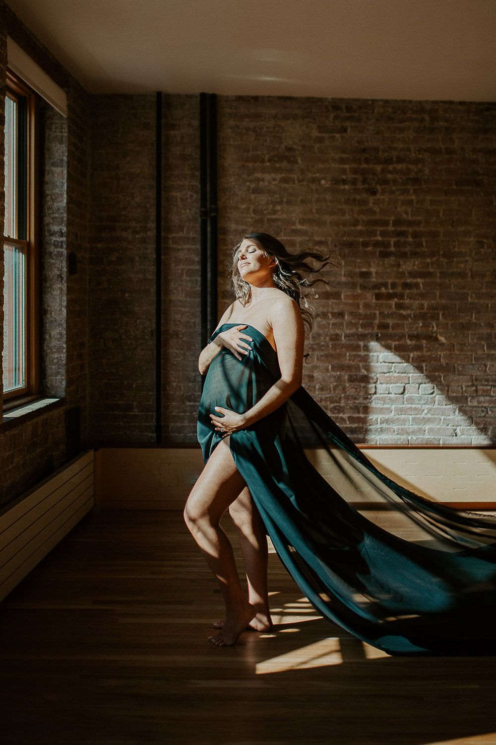 Naked pregnant woman during maternity session in nyc home