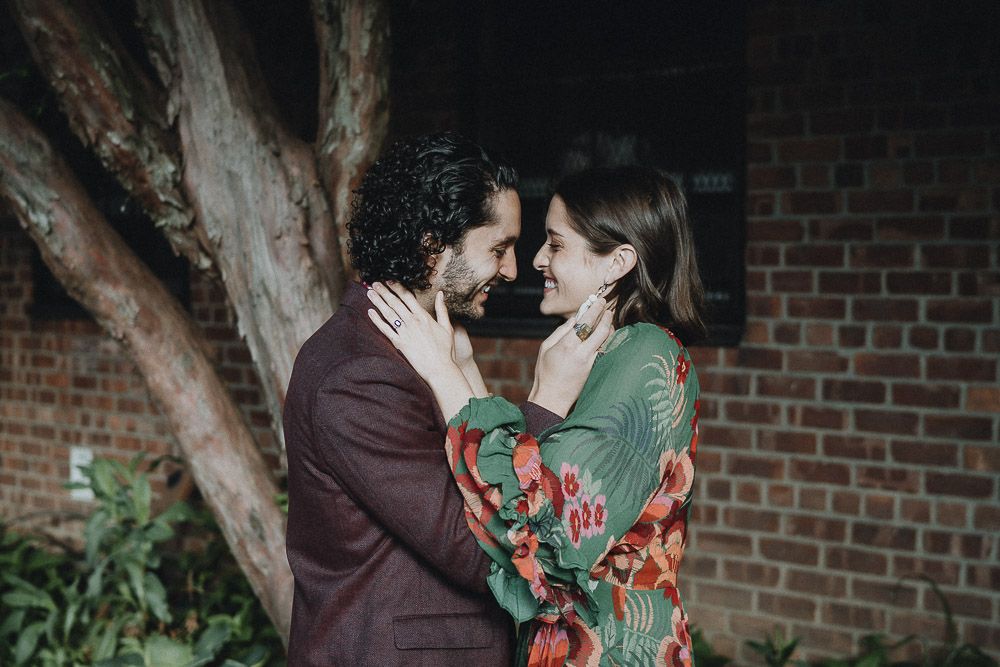 Couple laughing in brooklyn backyard during elopement